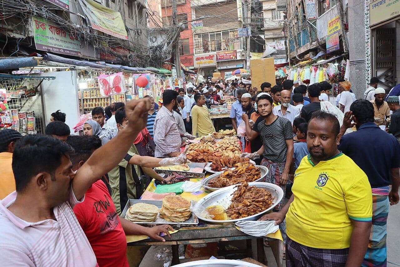 Crowds and heaped trays of food at the Chawkbazar iftar market in Old Dhaka.